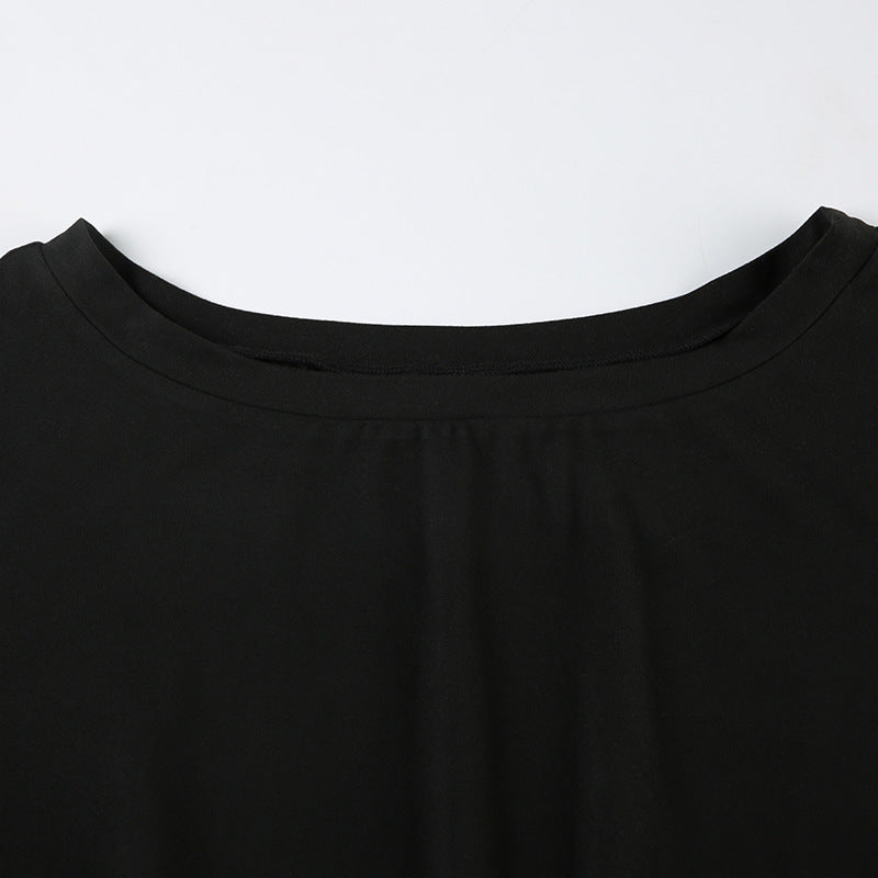 Close-up of black off-shoulder jumpsuit showing pleating design near neckline