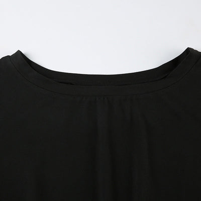 Close-up of black off-shoulder jumpsuit showing pleating design near neckline