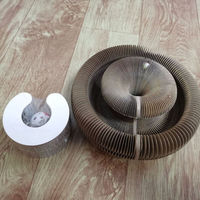 Corrugated and foldable cat paper nest on wooden floor for cat play and comfort