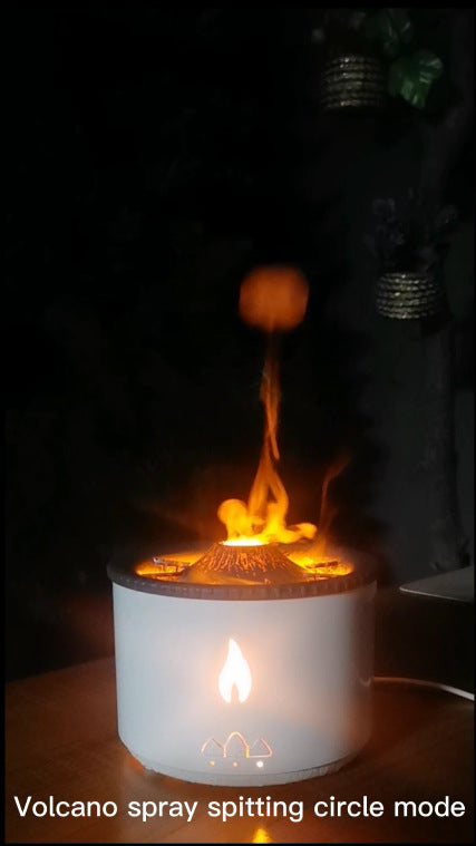 Ultrasonic essential oil humidifier with volcano-shaped design and glowing flame effect releasing mist in dark room