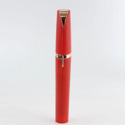 Flawlessly Brows Electric Eyebrow Remover in red with gold accents, portable and discreet design.