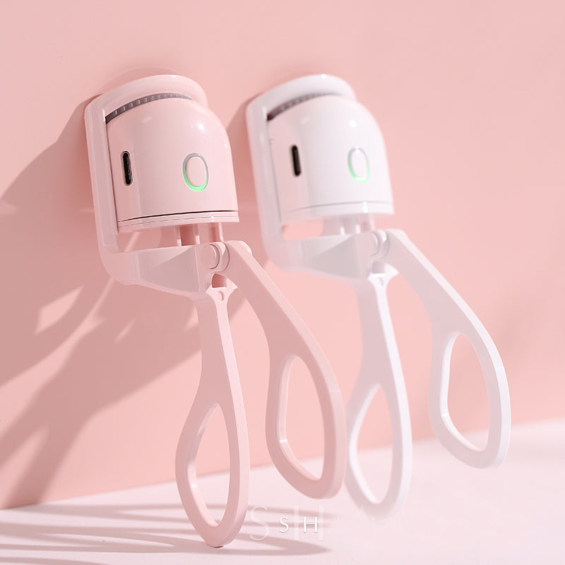 Portable USB rechargeable heated eyelash curlers in pink and white with ergonomic design and fast heating function