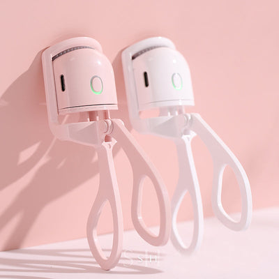 Portable USB rechargeable heated eyelash curlers in pink and white with ergonomic design and fast heating function