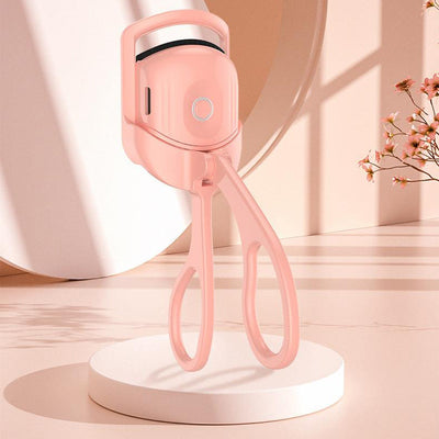Portable pink rechargeable electric heated eyelash curler with fast heating and dual temperature settings for long-lasting lash curls