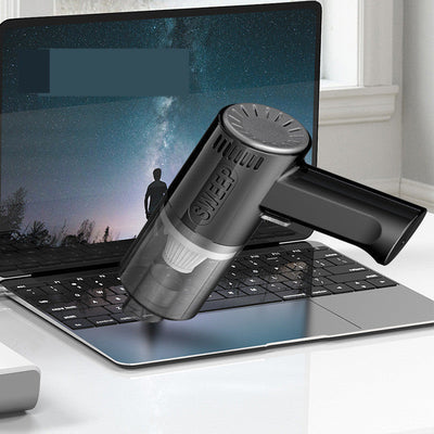 Dual purpose vacuum cleaner for wet and dry cleaning on a laptop keyboard.