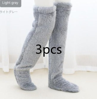 Over knee high light gray fuzzy socks for winter warmth.