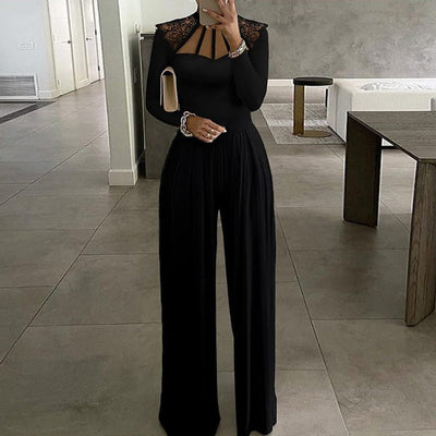 Women’s black long sleeve wide leg jumpsuit in milk silk fabric with stitching details and lace shoulders