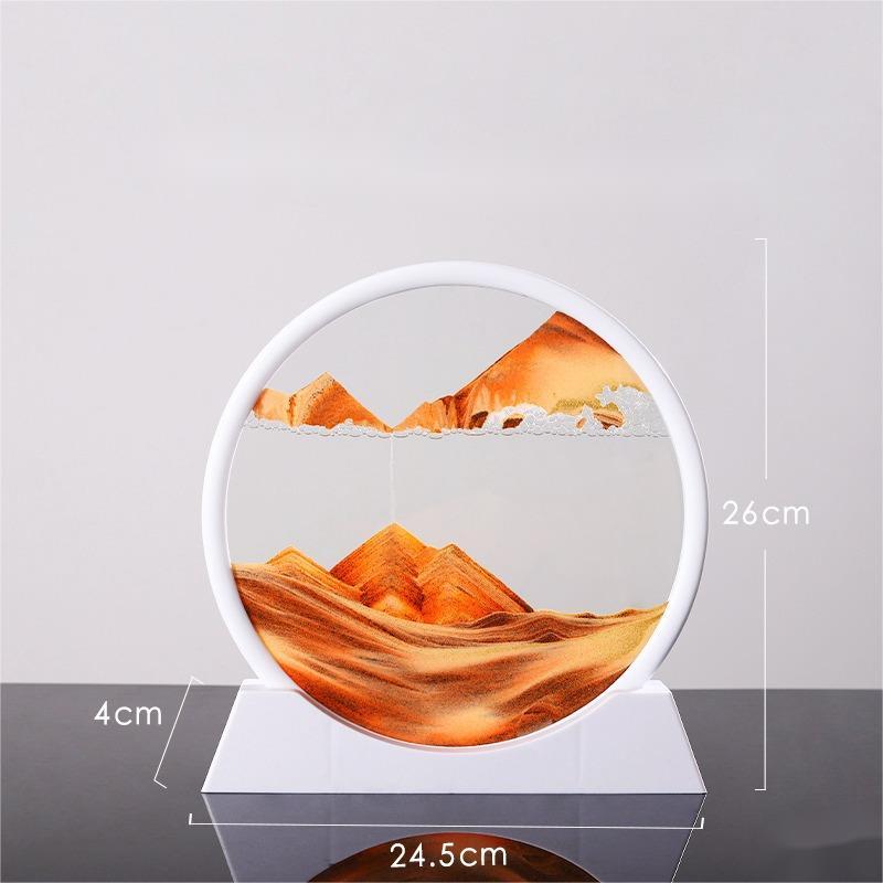 Quicksand painting glass ornament showing varying sand landscapes in circular frame.
