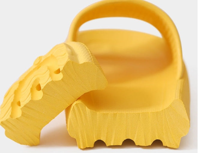 Yellow home household bathroom slippers with thick sole design.