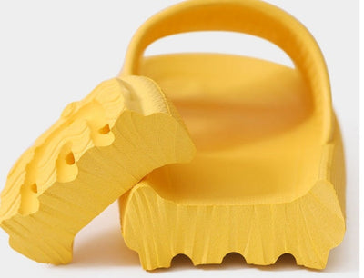 Yellow home household bathroom slippers with thick sole design.