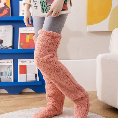 Over knee high fuzzy long socks in pink, providing warmth and comfort for winter, suitable for both men and women.