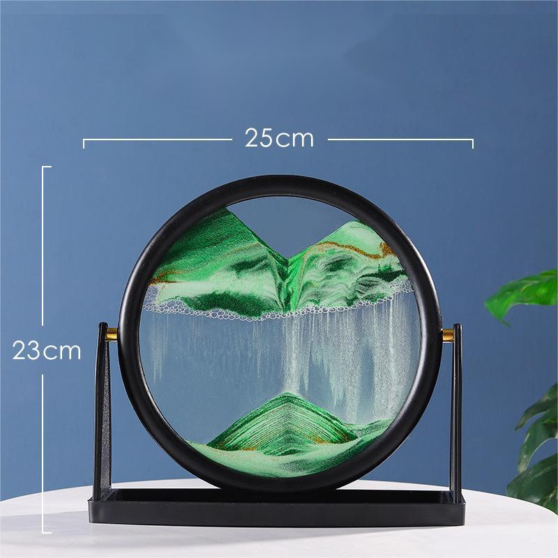 Quicksand painting hourglass ornament with green sand inside a circular glass frame, measuring 25cm by 23cm.