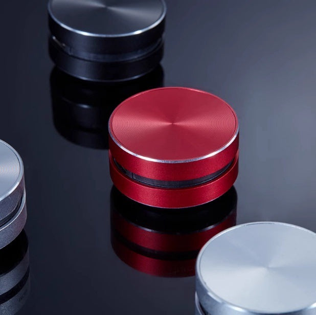 Bone conduction wireless Bluetooth speaker in multiple colors on a reflective surface.