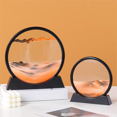 Quicksand painting hourglass ornaments with black frame on display.