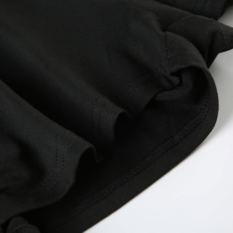 Close-up of black fabric showcasing pleating design detail on women's off-shoulder long sleeve loose jumpsuit